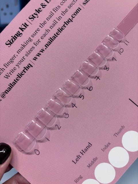 Pink nail size chart with clear gel nails on a pink background