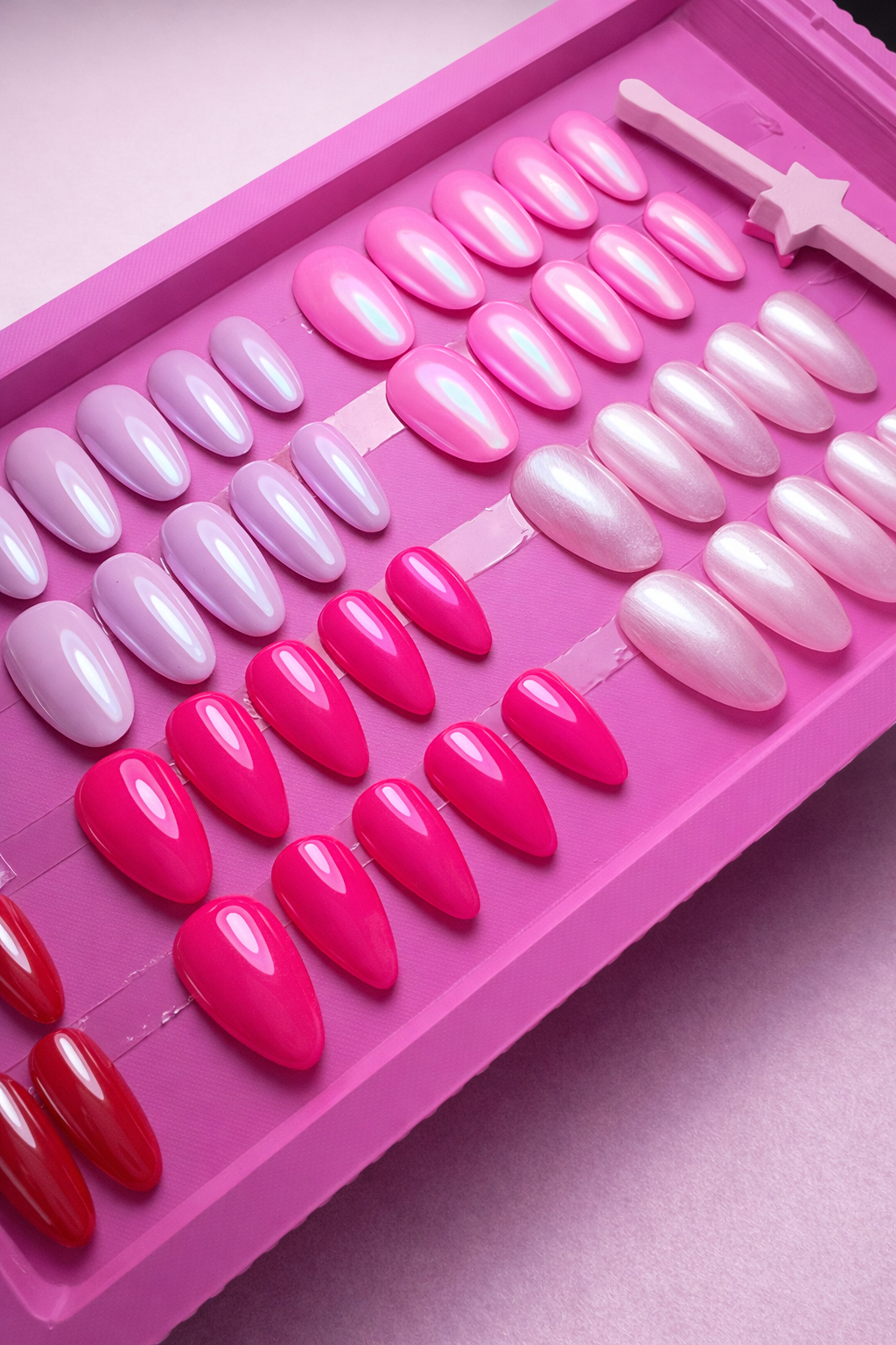 6 sets of press on nails. Nude, pinks and red with chrome and glossy top coat in a pink nail stand 