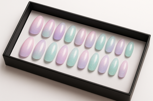 Professional product photography of a set of 24 pastel rainbow gradient press-on nails with iridescent glitter, soft pink to lavender to mint colors, unicorn-inspired design, elegant oval  shapes, arranged in luxury black packaging box, clean white background, whimsical beauty product styling, realistic nail texture"